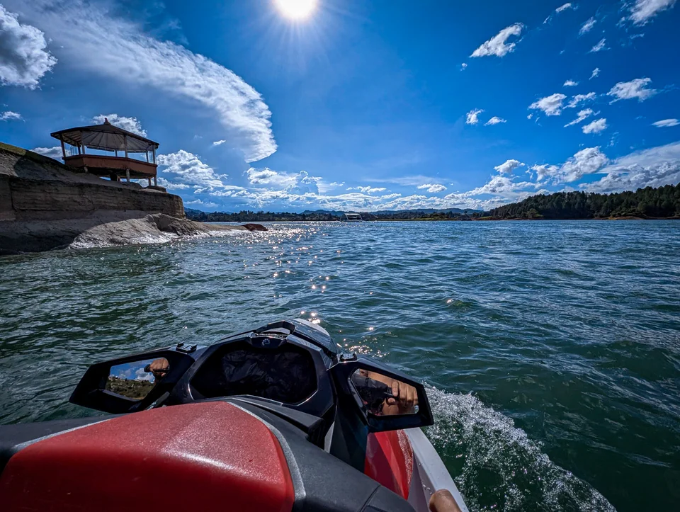 View from a boat on a lake surrounded by mountains.