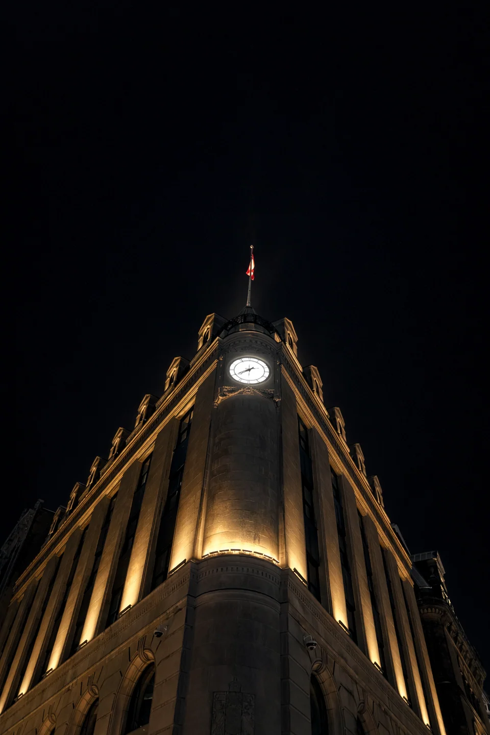 Building photographed from below with golden lighting against the night.
