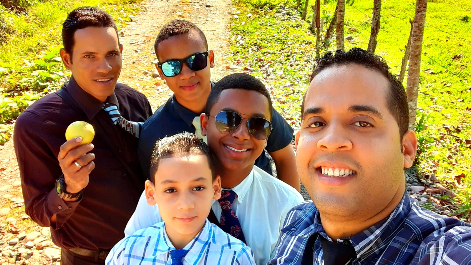A group of people of different ages outdoors during the preaching work