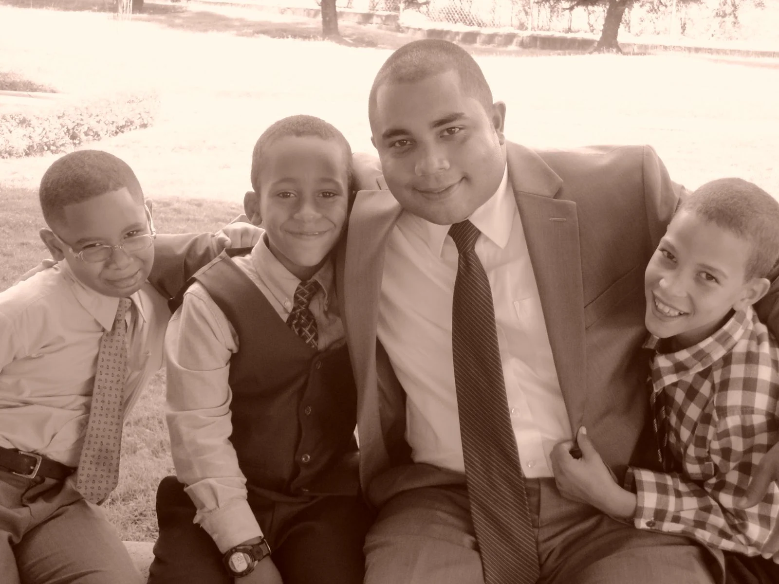An adult and three children sharing a moment during the preaching work